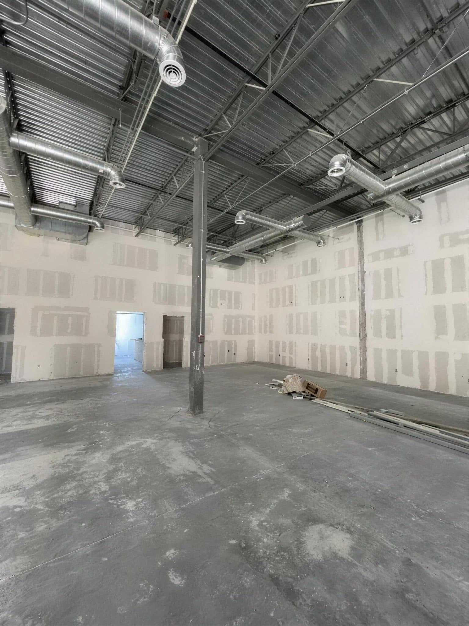 Pulze gym in Pharr before painting, with taped drywall and an exposed steel roof deck.